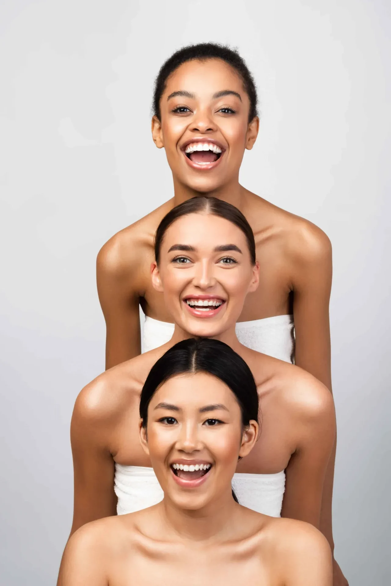 Three women smiling in a stacked pose