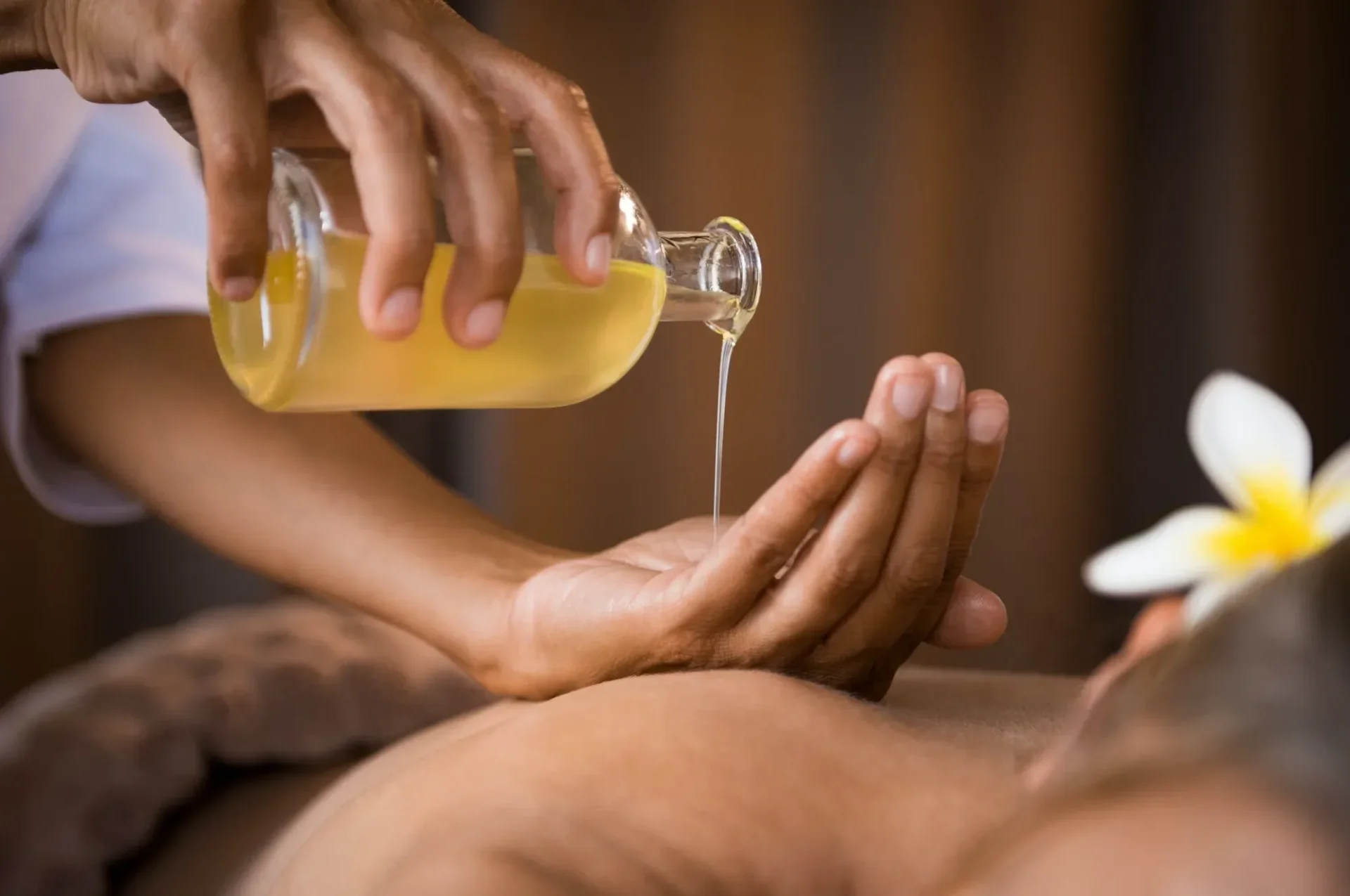 Massage oil being poured gently