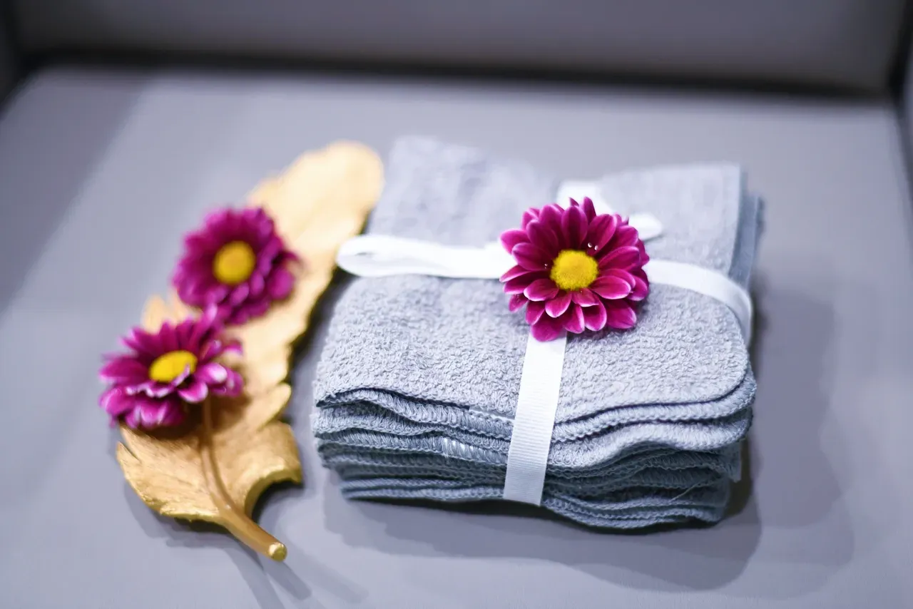 Folded towels with purple flowers