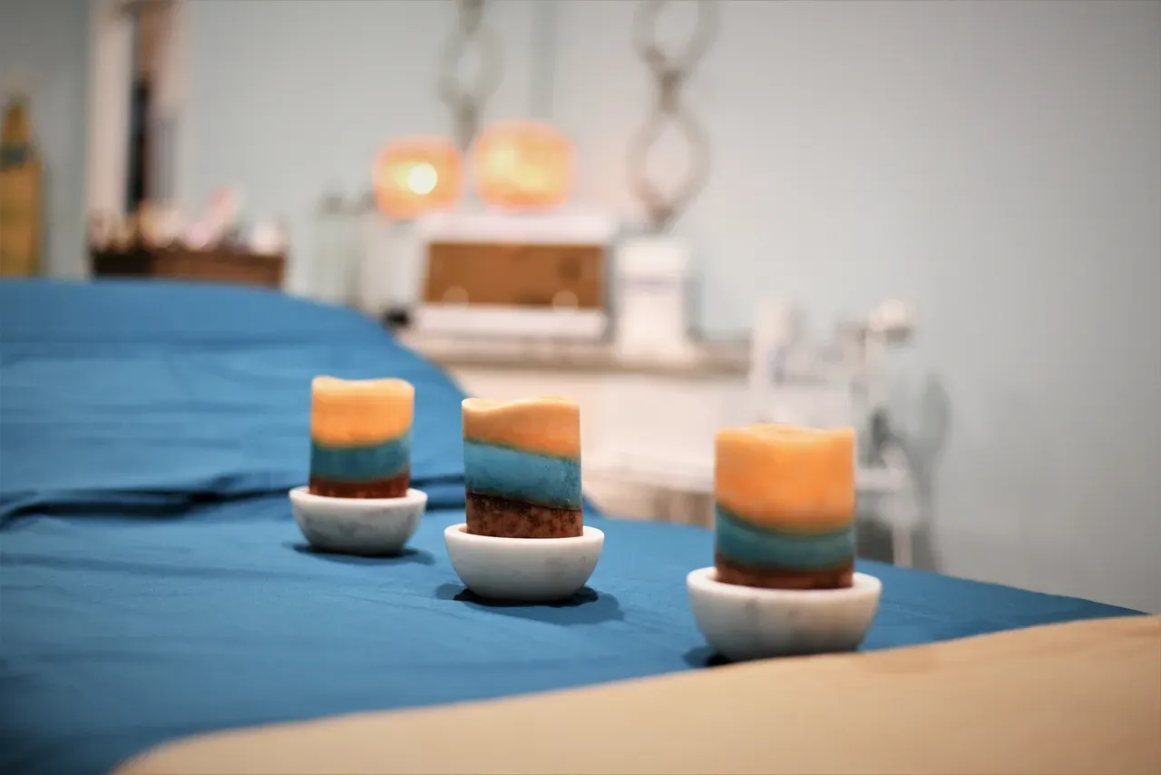 Three candles in a tranquil spa setting