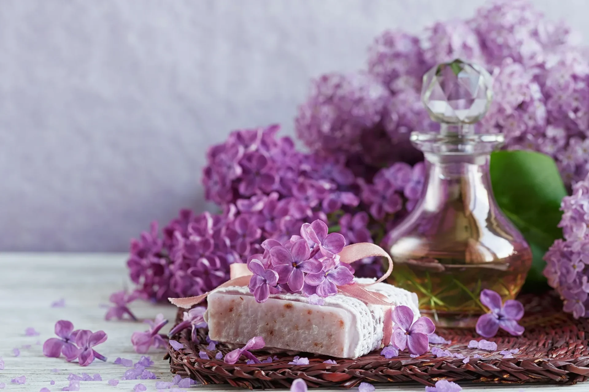 Purple lilacs with soap and crystal bottle